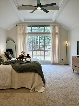 a bedroom with a bed and a large window