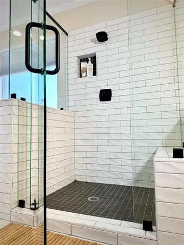 a bathroom with a shower and a mirror