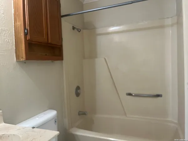 a bathroom with a shower and a toilet