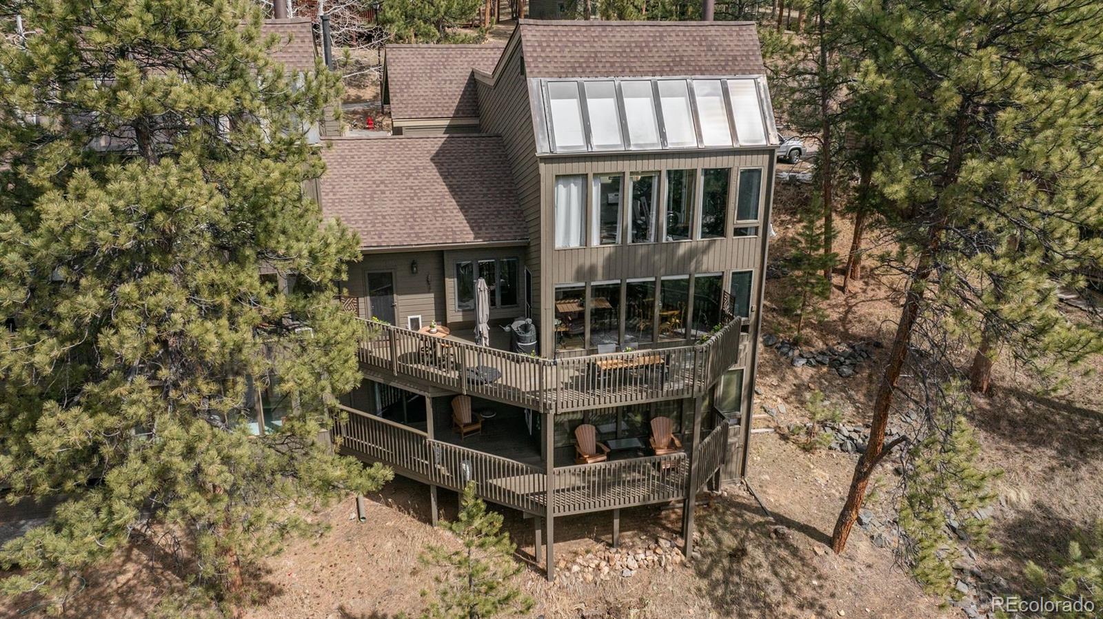 an aerial view of a house with balcony and deck