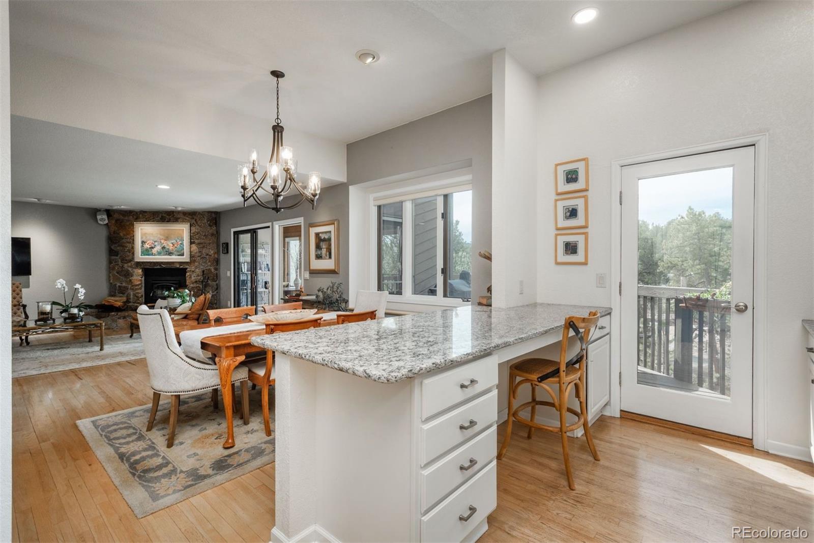 4192 Timbervale Drive Evergreen, CO 80439 - Photo 15 of 50 a dining room with chandelier and wooden floor