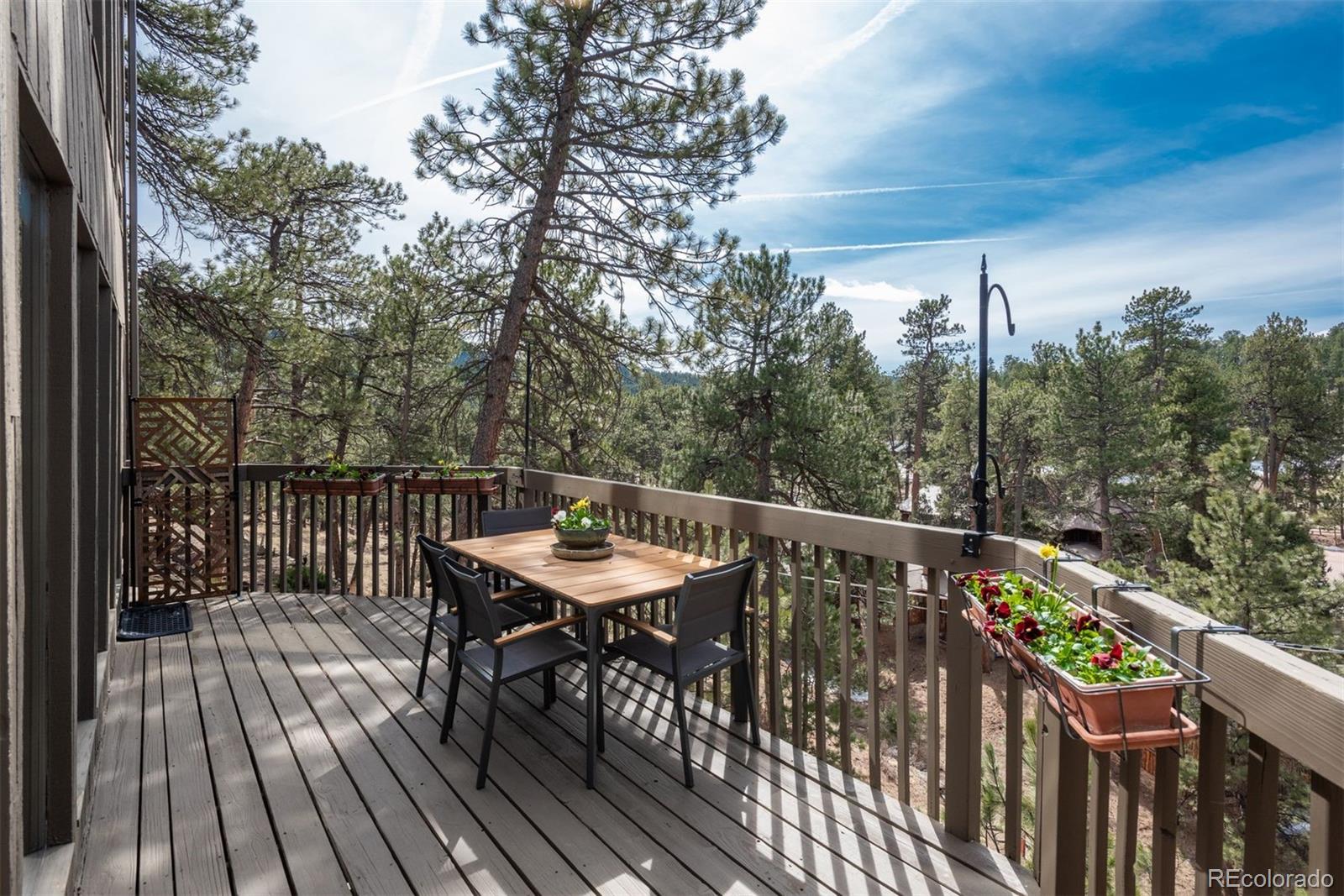 4192 Timbervale Drive Evergreen, CO 80439 - Photo 17 of 50 a balcony with wooden floor and outdoor seating