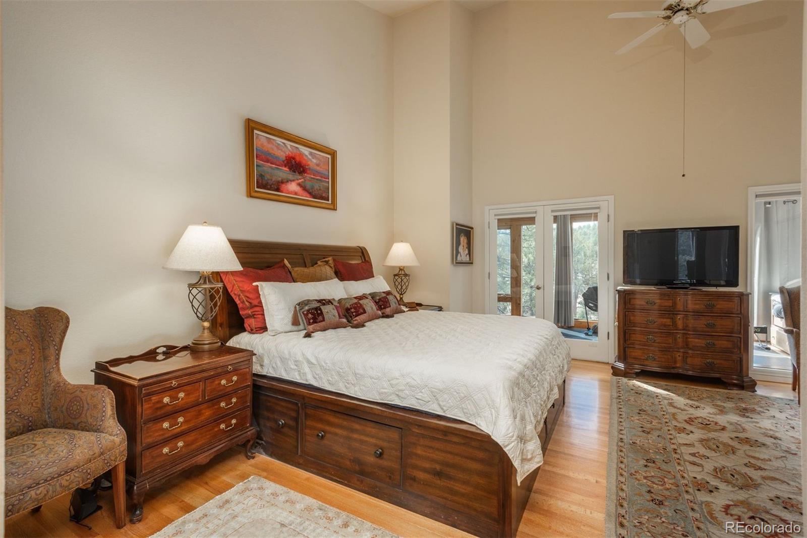 4192 Timbervale Drive Evergreen, CO 80439 - Photo 27 of 50 a bedroom with bed and wooden floor