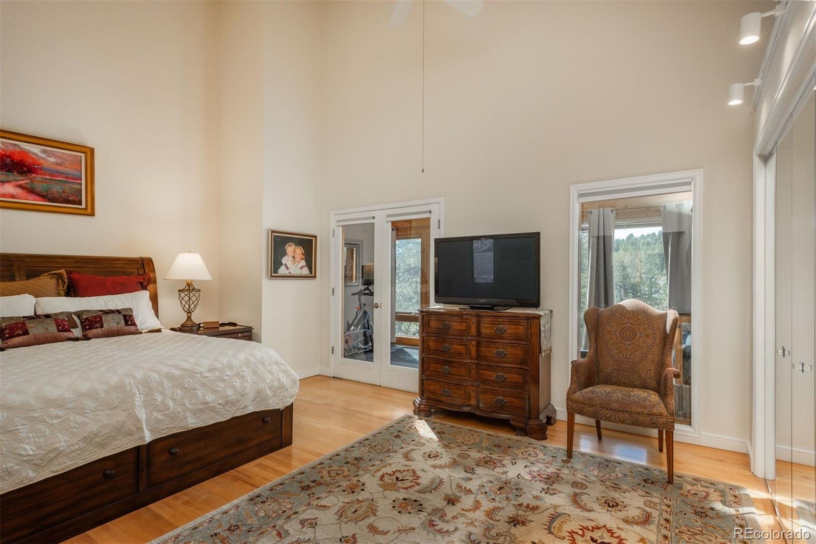 4192 Timbervale Drive Evergreen, CO 80439 - Photo 29 of 50 a bedroom with a bed and furniture