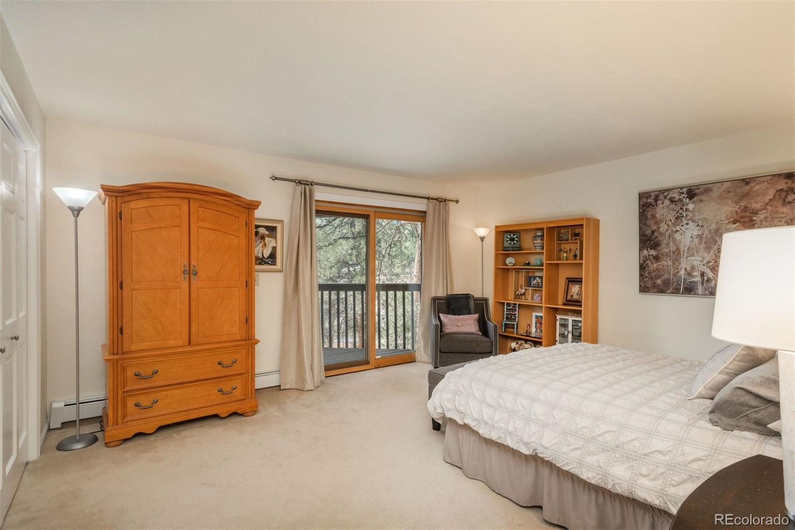 4192 Timbervale Drive Evergreen, CO 80439 - Photo 36 of 50 a bed room with a bed and a chair