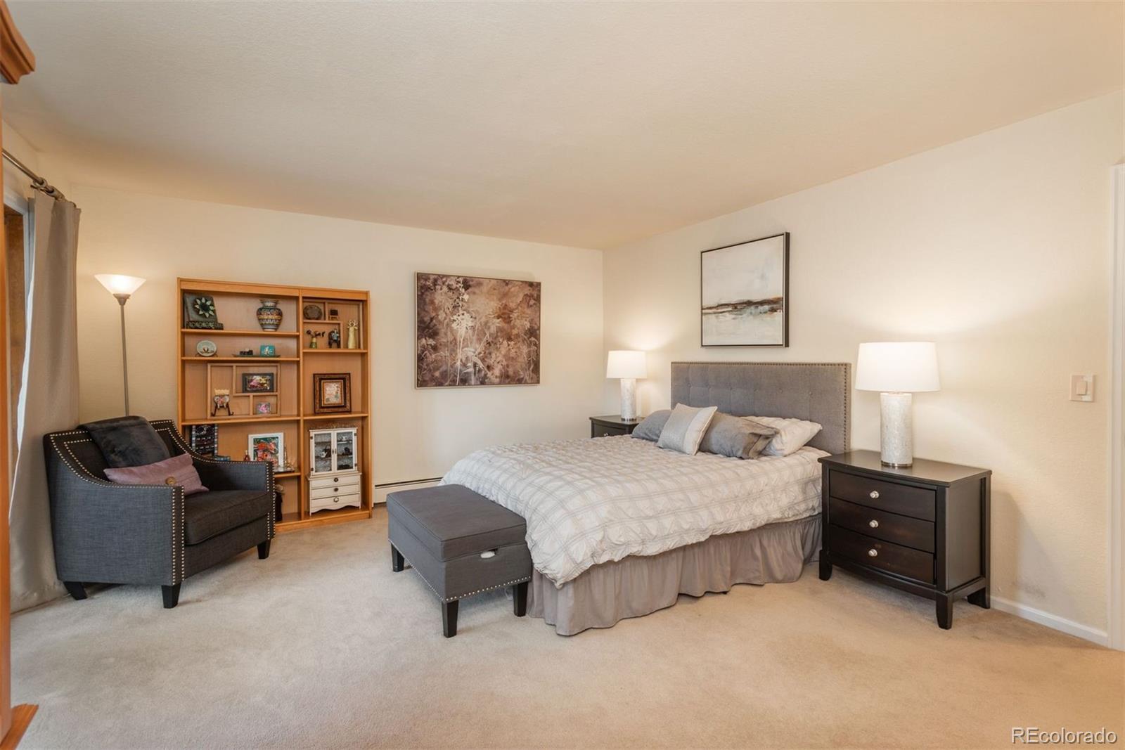 4192 Timbervale Drive Evergreen, CO 80439 - Photo 40 of 50 a spacious bedroom with a bed and couch