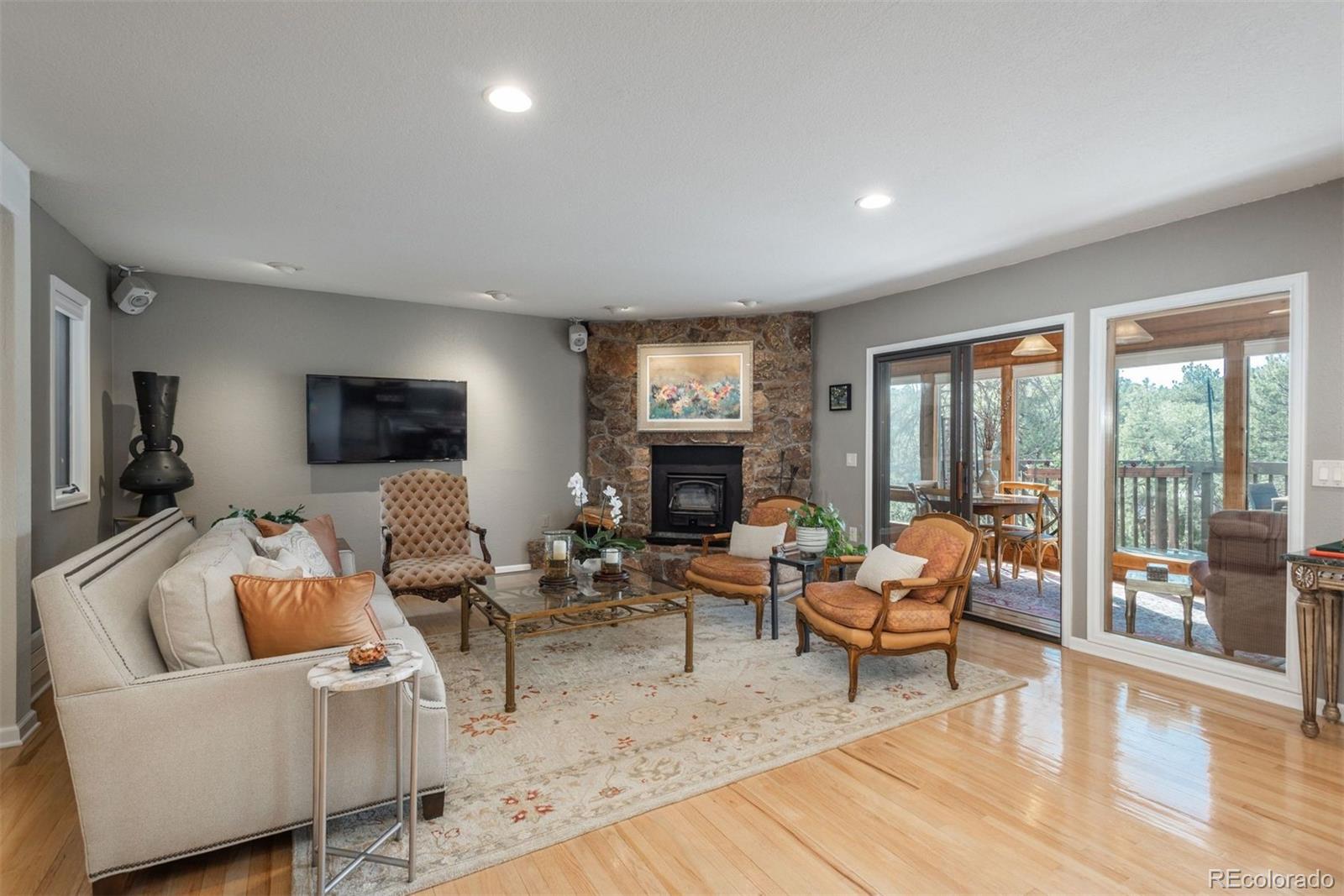 4192 Timbervale Drive Evergreen, CO 80439 - Photo 5 of 50 a living room with furniture and a fireplace