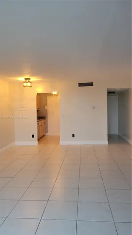 a view of a livingroom with an empty space and a window