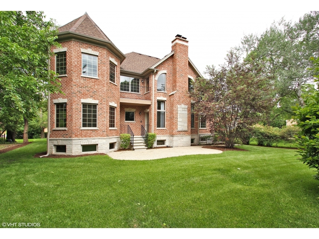 713 Greenwood Road Glenview, IL 60025 - Photo 8 of 11 a front view of a house with a yard and porch