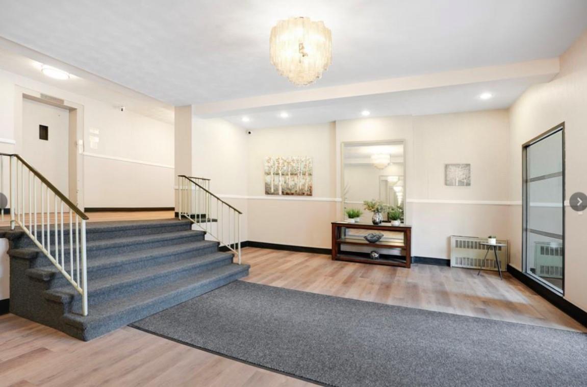2261 Palmer Avenue, Unit 2A New Rochelle, NY 10801 - Photo 2 of 12 a living room with furniture and a chandelier