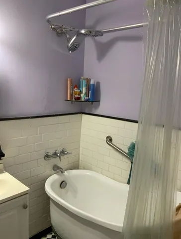 a bathroom with a sink and a shower curtain