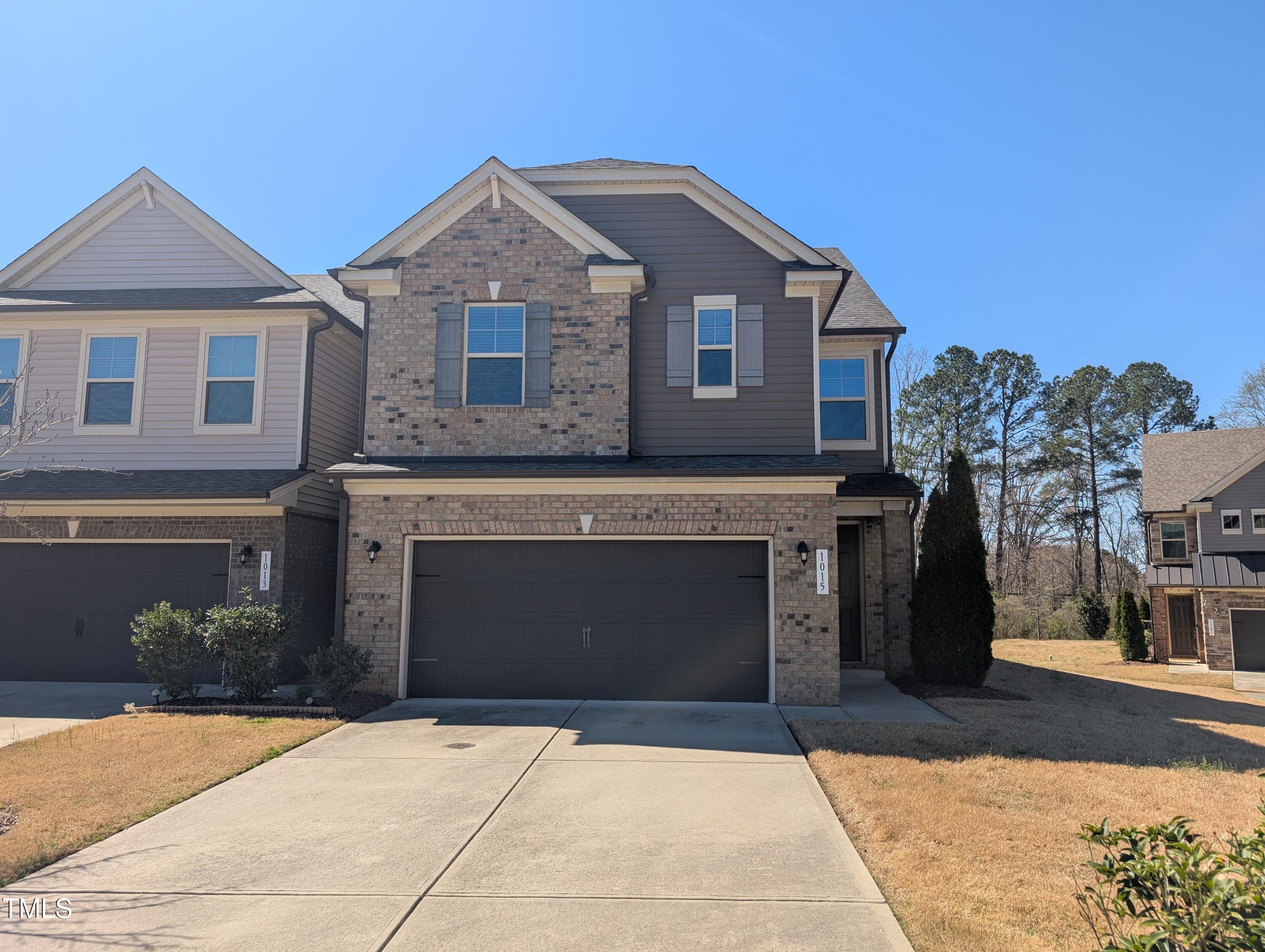 1015 Rexburg Drive Cary, NC 27513 - Photo 1 of 29 a front view of a house with a yard and garage