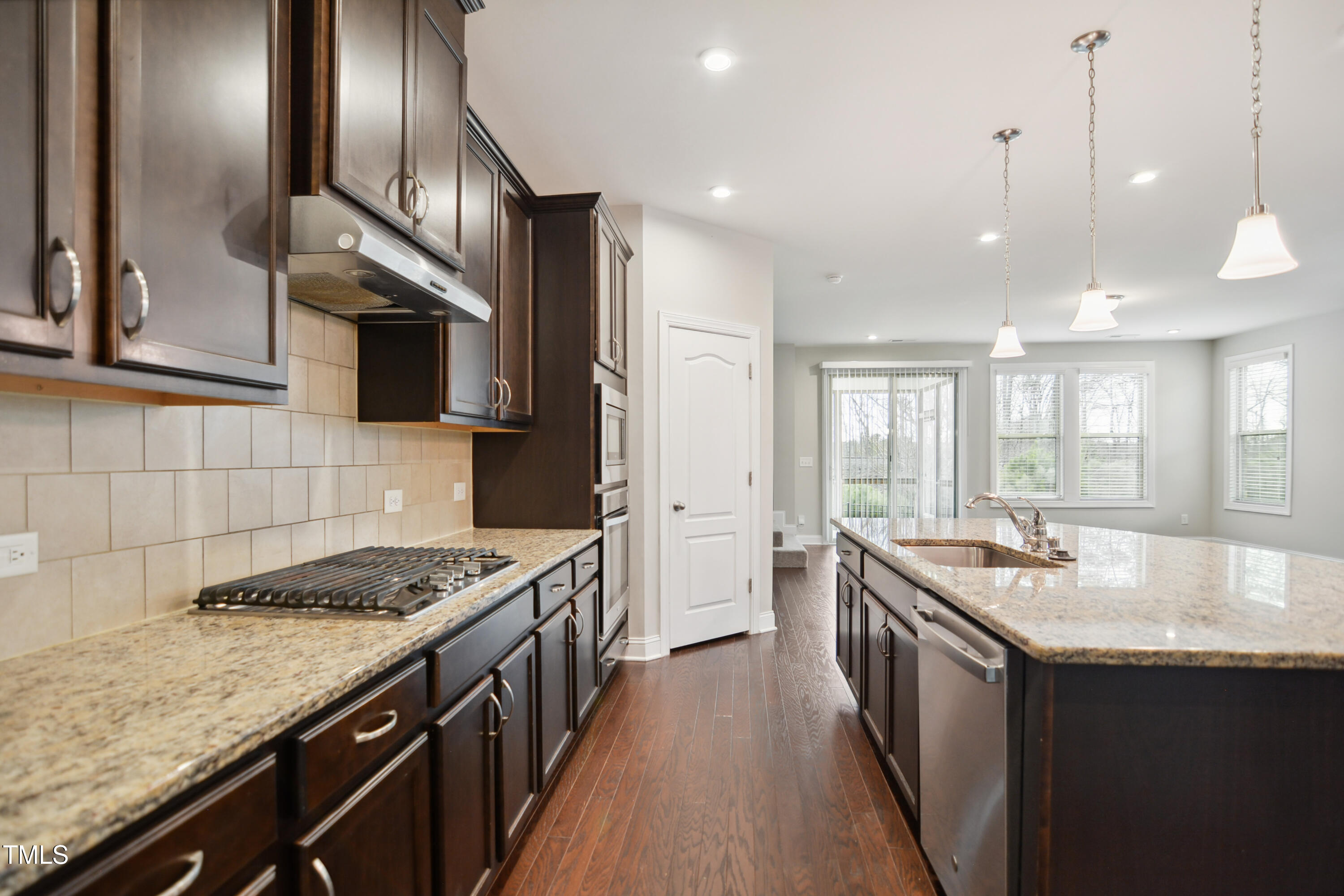 1015 Rexburg Drive Cary, NC 27513 - Photo 11 of 29 a kitchen with stainless steel appliances granite countertop a sink stove and refrigerator