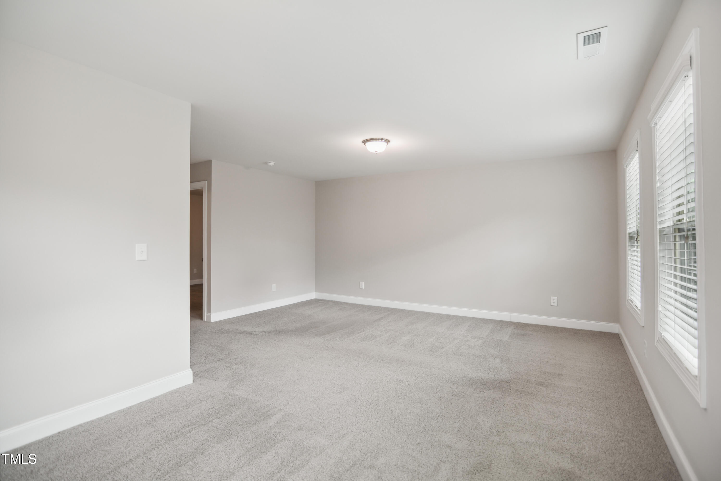1015 Rexburg Drive Cary, NC 27513 - Photo 14 of 29 an empty room with windows