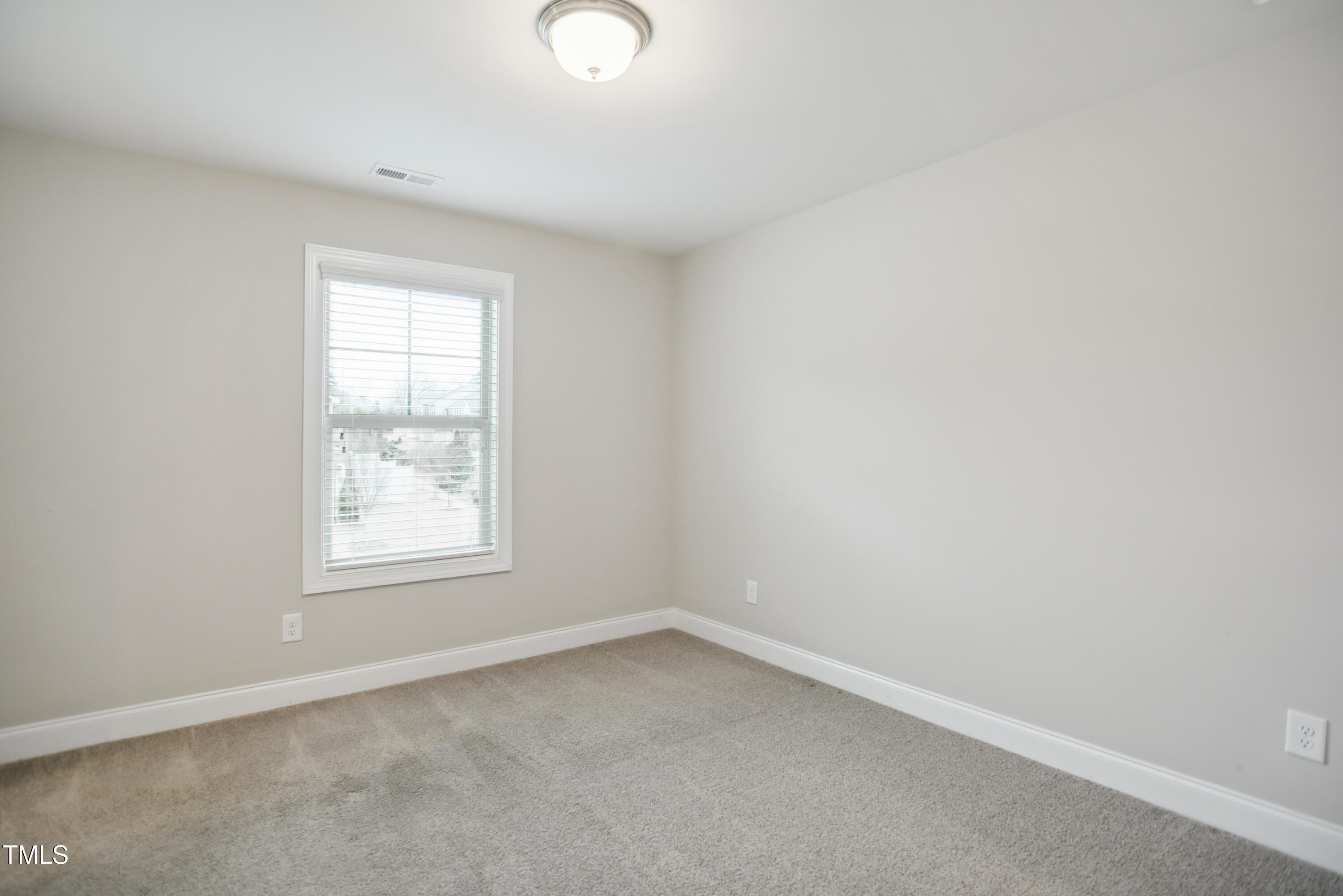 1015 Rexburg Drive Cary, NC 27513 - Photo 18 of 29 an empty room with a window