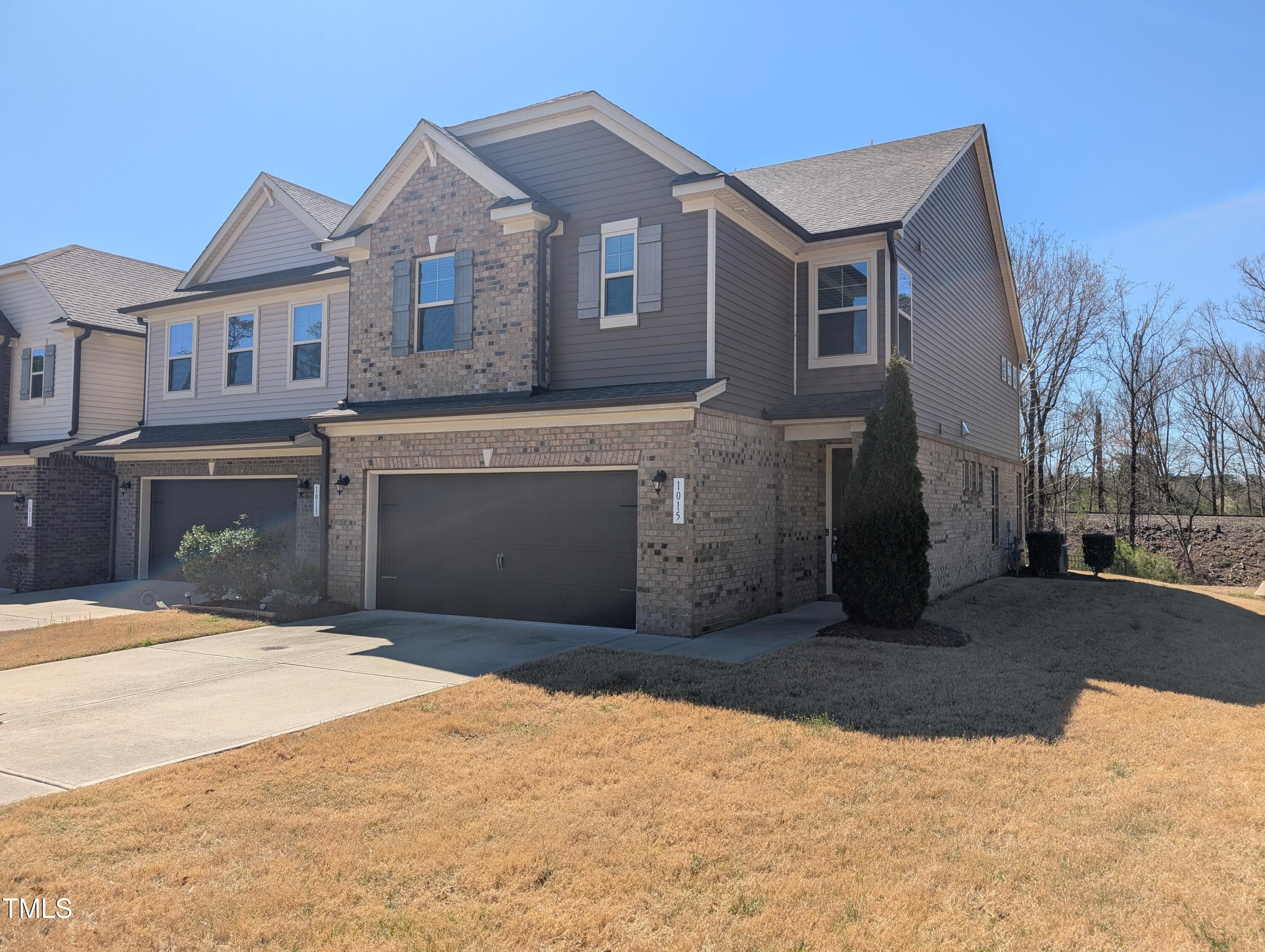 1015 Rexburg Drive Cary, NC 27513 - Photo 2 of 29 a front view of a house with a yard
