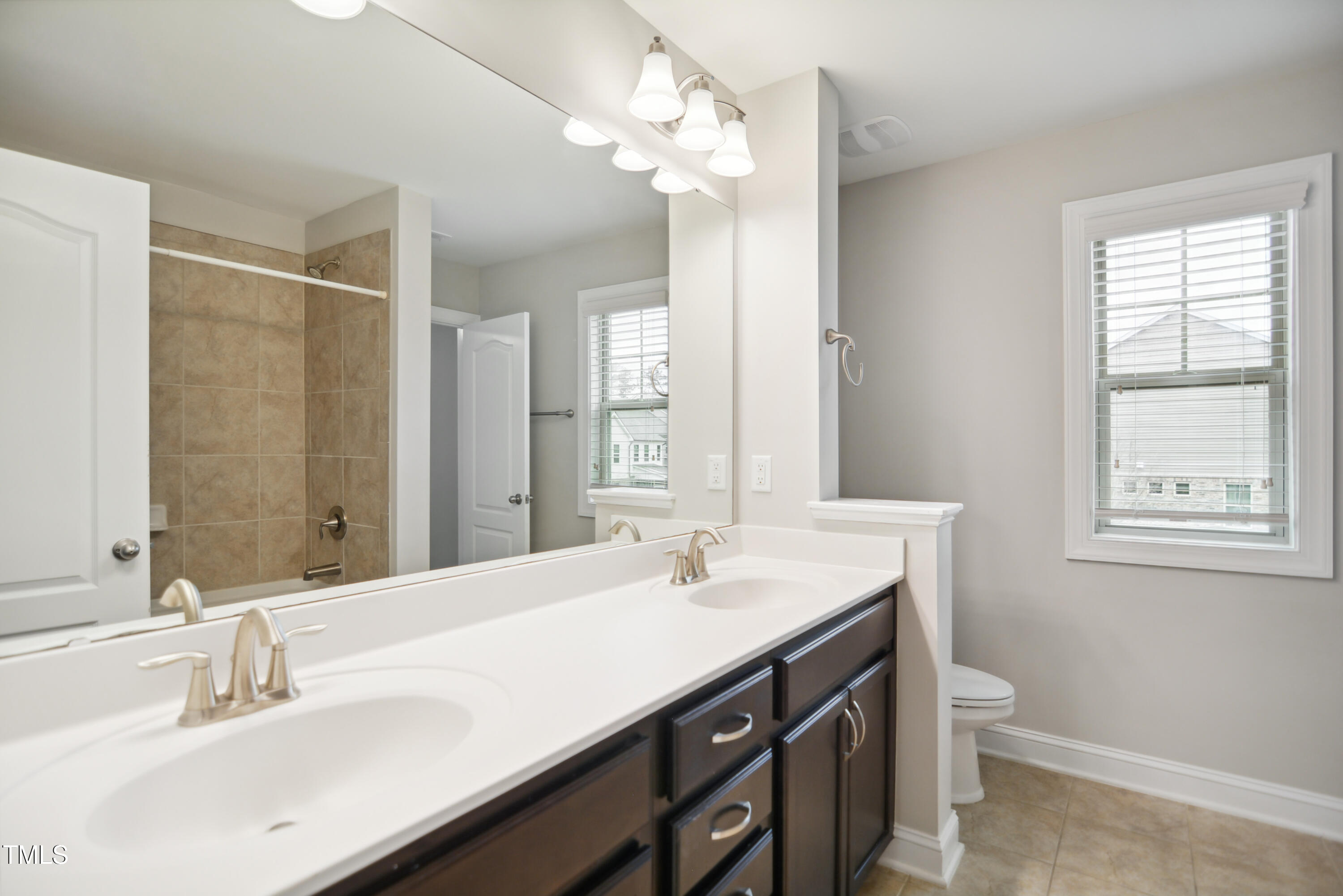1015 Rexburg Drive Cary, NC 27513 - Photo 23 of 29 a bathroom with a sink double vanity and a mirror