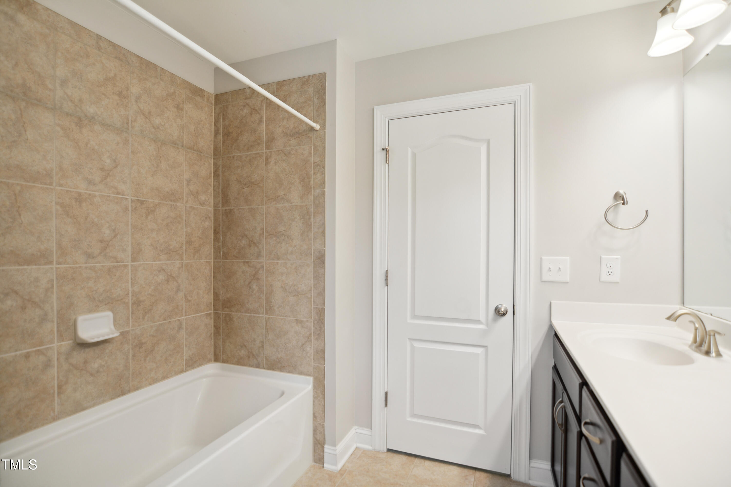 1015 Rexburg Drive Cary, NC 27513 - Photo 25 of 29 a bathroom with a bathtub and a sink