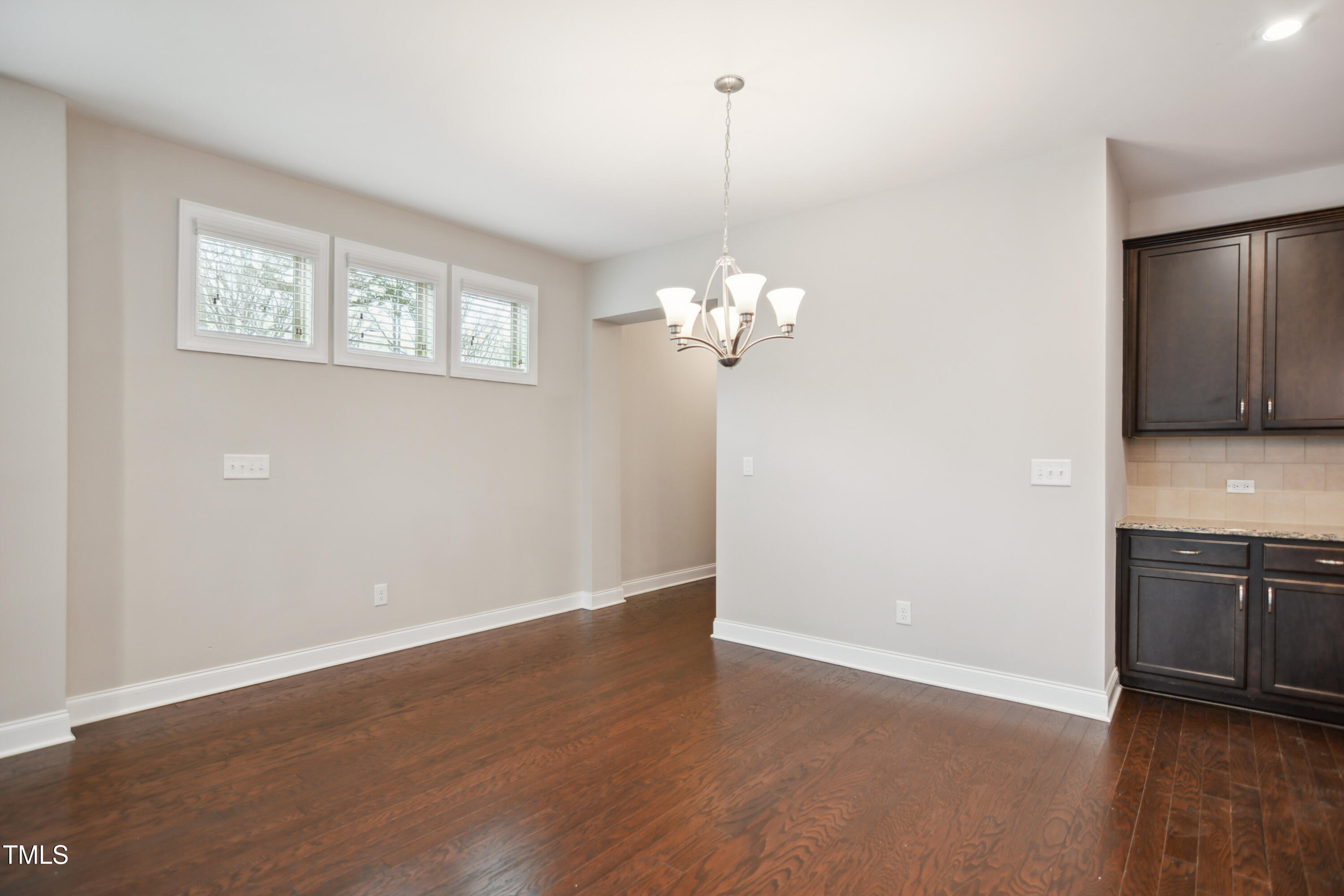 1015 Rexburg Drive Cary, NC 27513 - Photo 7 of 29 a view of a kitchen with wooden floor and stainless steel appliances