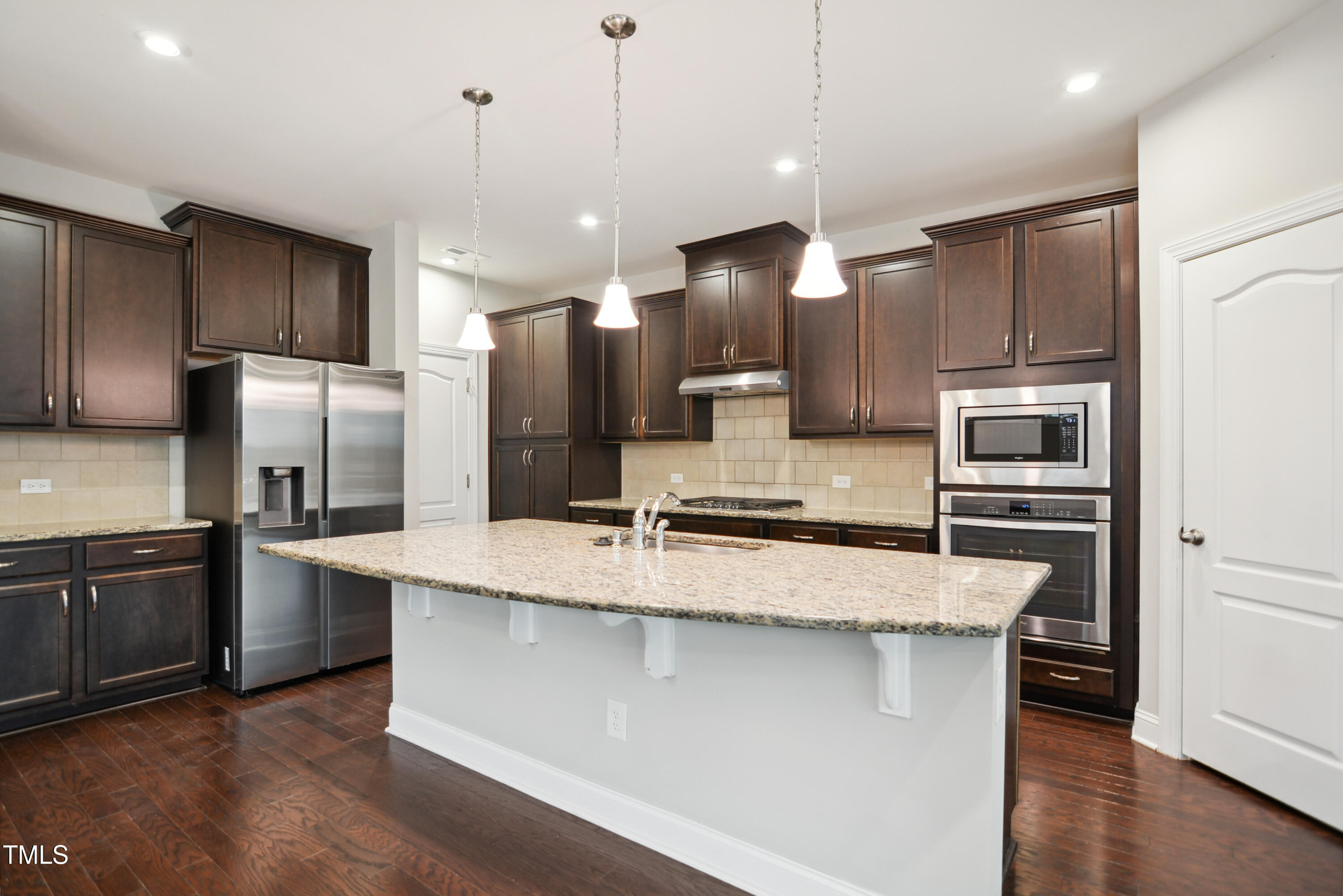 1015 Rexburg Drive Cary, NC 27513 - Photo 9 of 29 a modern kitchen with stainless steel appliances kitchen island a large island in the center