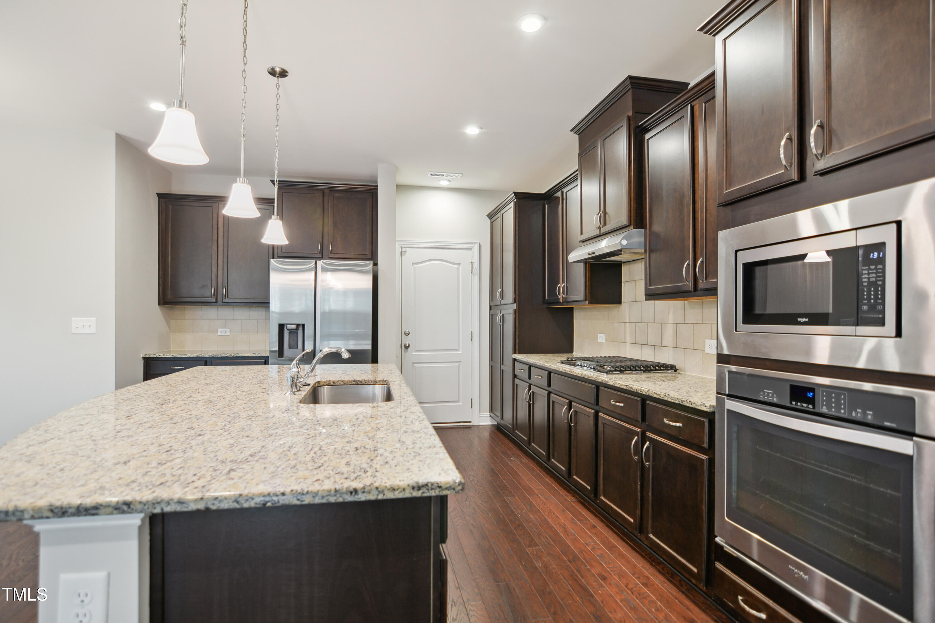 1015 Rexburg Drive Cary, NC 27513 - Photo 10 of 29 a kitchen with stainless steel appliances granite countertop a sink a stove and oven