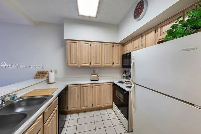 a kitchen with a sink appliances and cabinets