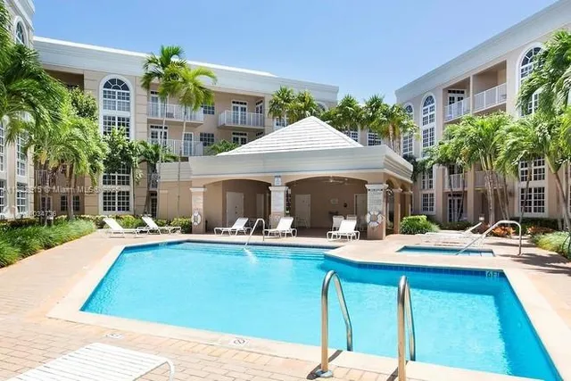 a patio with a table and chairs under an umbrella