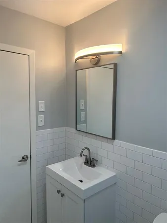 a bathroom with a sink a mirror and vanity