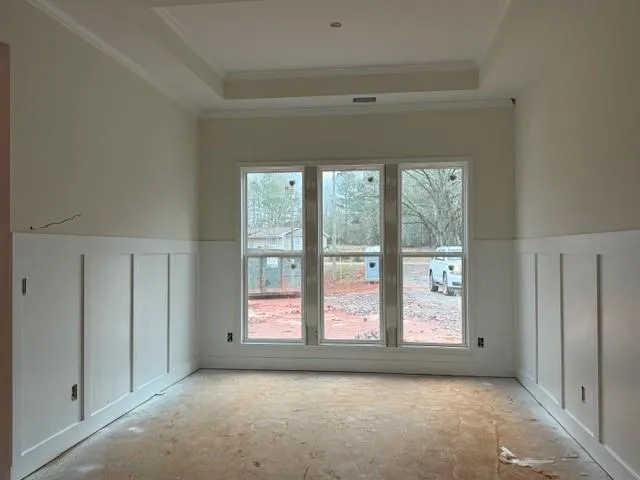 an empty room with a fireplace and windows