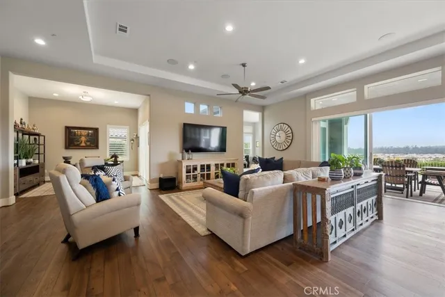 a living room with furniture a rug and a flat screen tv
