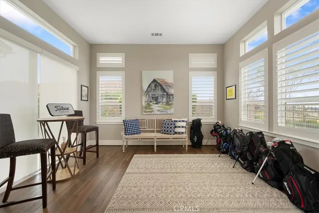 a large bedroom with bed and large windows