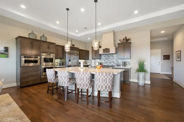 a kitchen with lots of counter top space appliances and cabinets