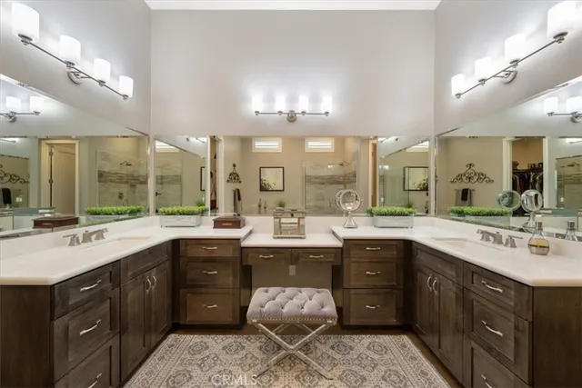 a large bathroom with a large tub sink and glass door