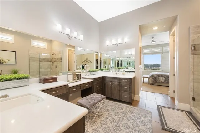 a bathroom with a granite countertop sink a mirror and shower