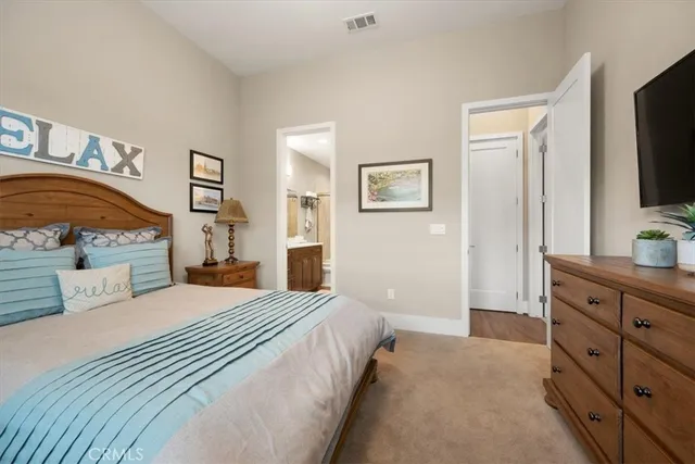 a bathroom with a sink a toilet a large mirror and shower