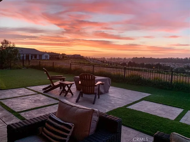 a view of a patio with table and chairs with wooden floor and fence