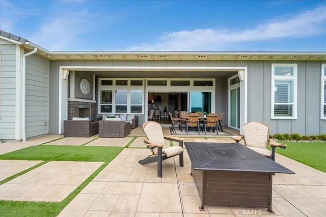a view of a house with backyard patio and swimming pool