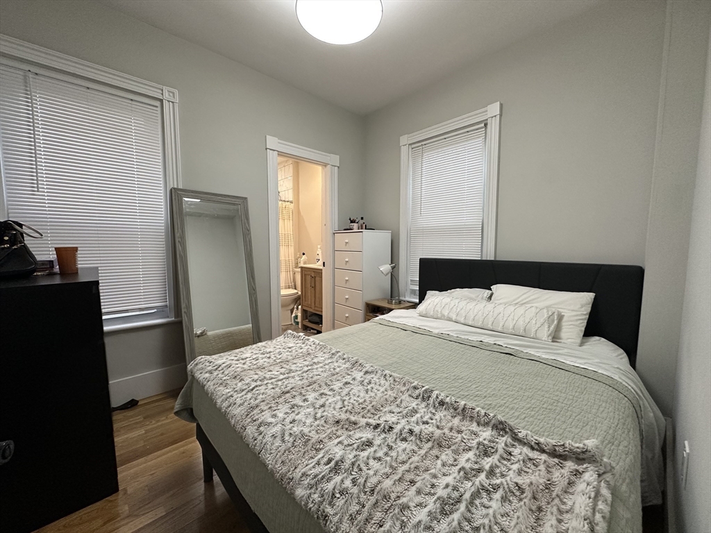 68 L Street, Unit 1 Boston, MA 02127 - Photo 10 of 12 a bedroom with a bed and wooden floor