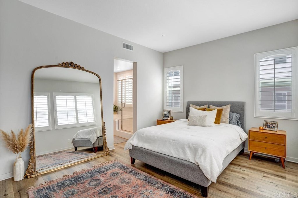 2048 Bravo Loop, Unit 2 Chula Vista, CA 91915 - Photo 16 of 34 a bedroom with a bed and a mirror