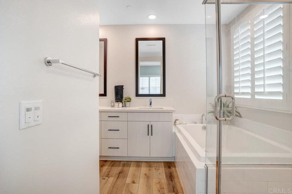 2048 Bravo Loop, Unit 2 Chula Vista, CA 91915 - Photo 17 of 34 a bathroom with a double vanity sink a mirror and a bathtub