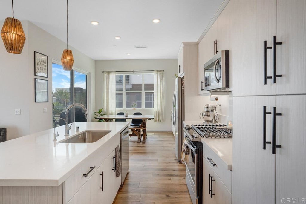 2048 Bravo Loop, Unit 2 Chula Vista, CA 91915 - Photo 2 of 34 a kitchen with a sink stainless steel appliances a counter space and a window