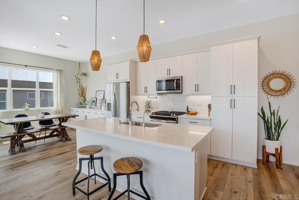 2048 Bravo Loop, Unit 2 Chula Vista, CA 91915 - Photo 3 of 34 a kitchen with sink cabinets and wooden floor