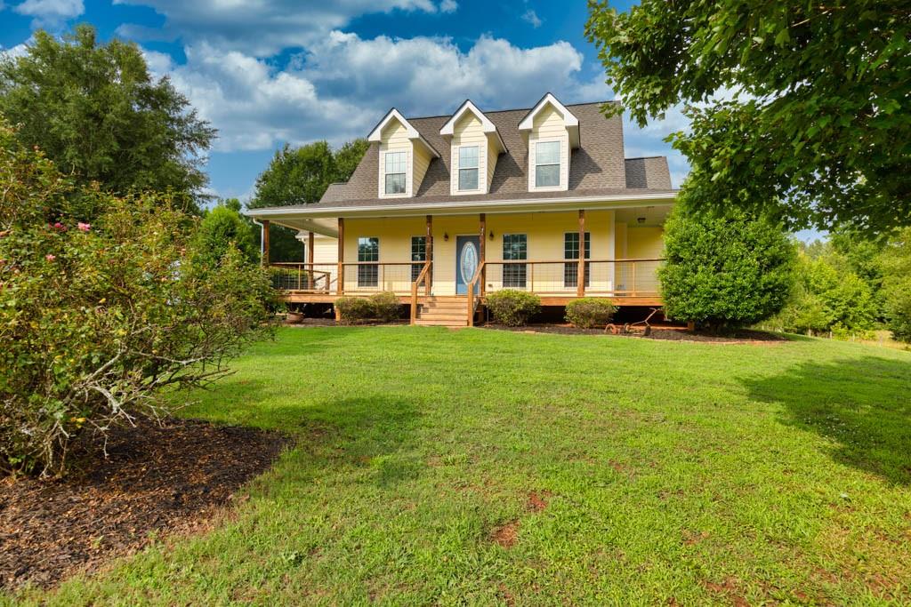 1521 Locklin Cemetery Road Monroe, GA 30655 - Photo 1 of 1 a view of a white house with a big yard and large trees