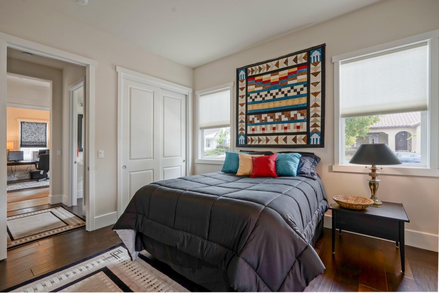 18527 McClellan Circle Marina, CA 93933 - Photo 16 of 35 a bedroom with a bed and a lamp on table with wooden floor