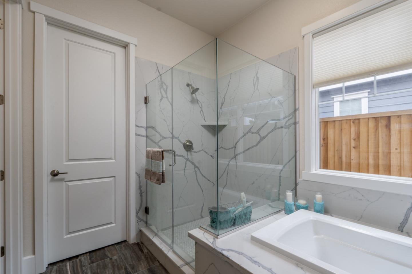 18527 McClellan Circle Marina, CA 93933 - Photo 25 of 35 a bathroom with a granite countertop sink and shower