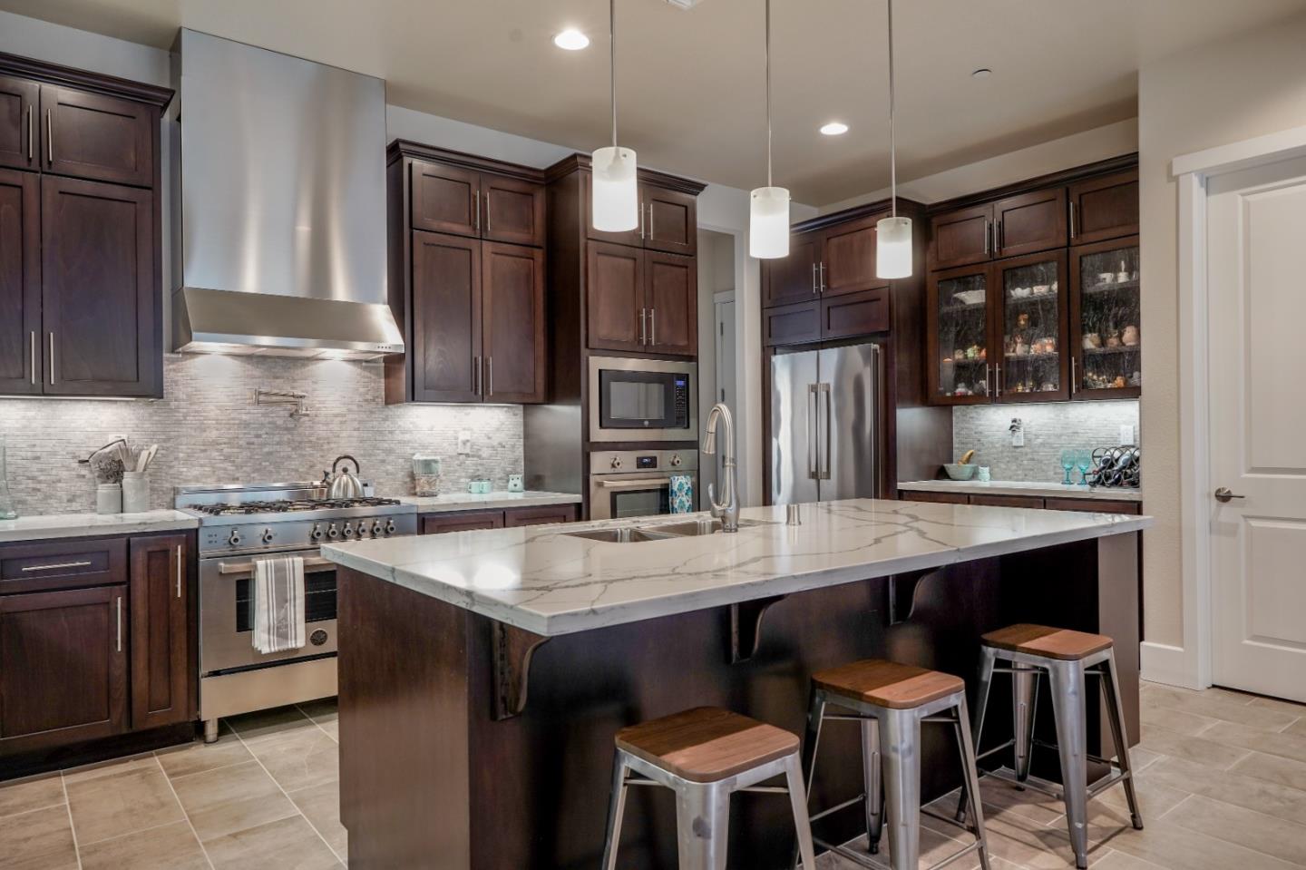 18527 McClellan Circle Marina, CA 93933 - Photo 4 of 35 a kitchen with stainless steel appliances granite countertop a stove a sink and a refrigerator