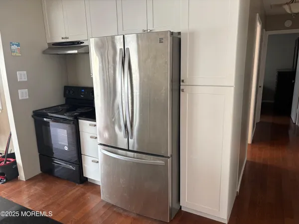 a metallic refrigerator freezer sitting in a kitchen