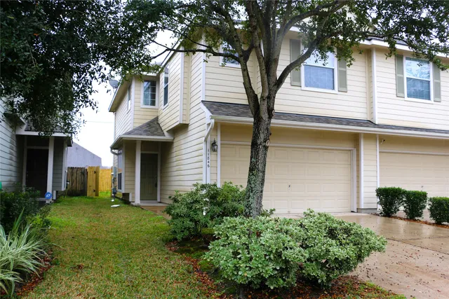 a front view of a house with a yard and trees