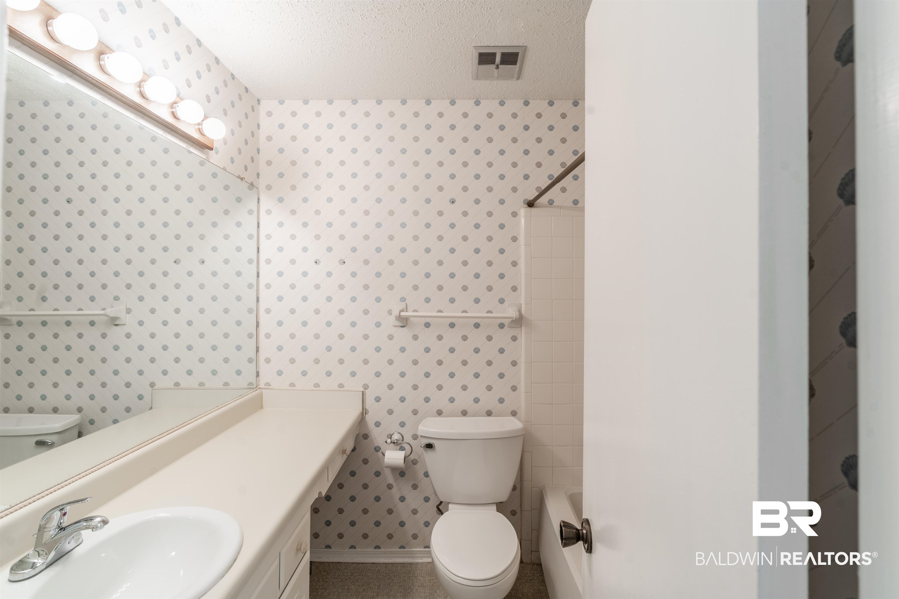 9751 Pine Knoll Road Mobile, AL 36608 - Photo 15 of 36 Bathroom featuring wallpapered walls, shower / bath combination, vanity, and a textured ceiling