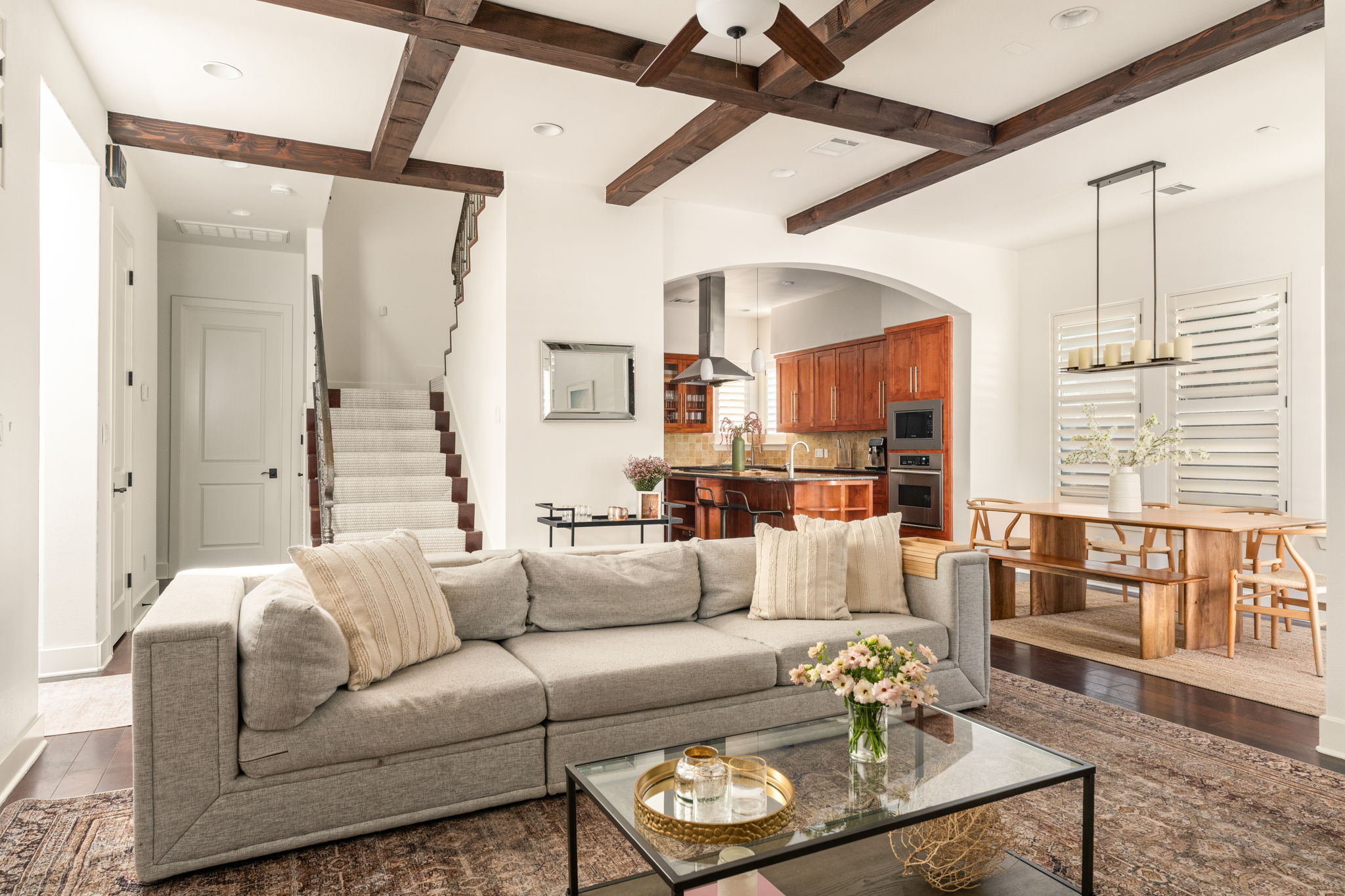 2324 Kinney Road Austin, TX 78704 - Photo 4 of 35 Richly stained ceiling beams and dark hardwood flooring elevate this open main-level living space.